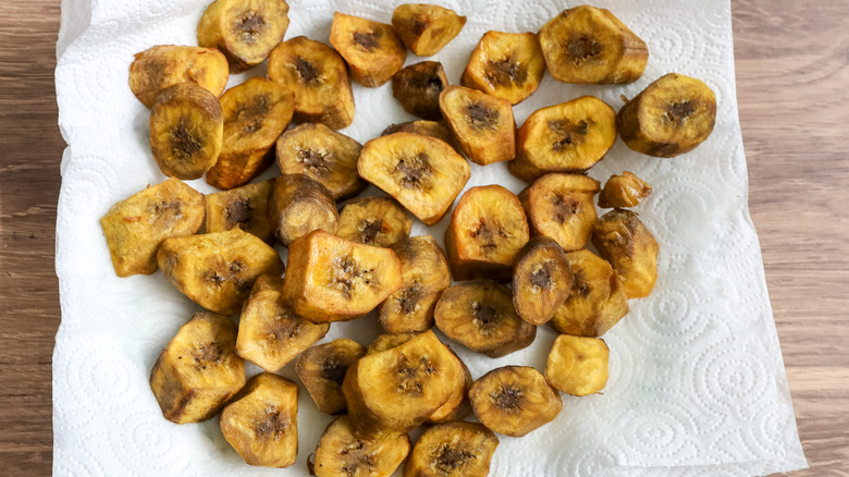 fried plantains on a paper towel lined plate