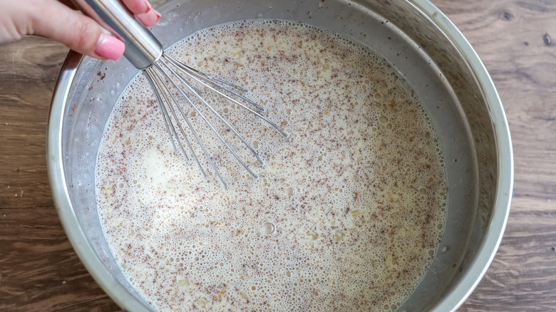 custard in a bowl with a whisk