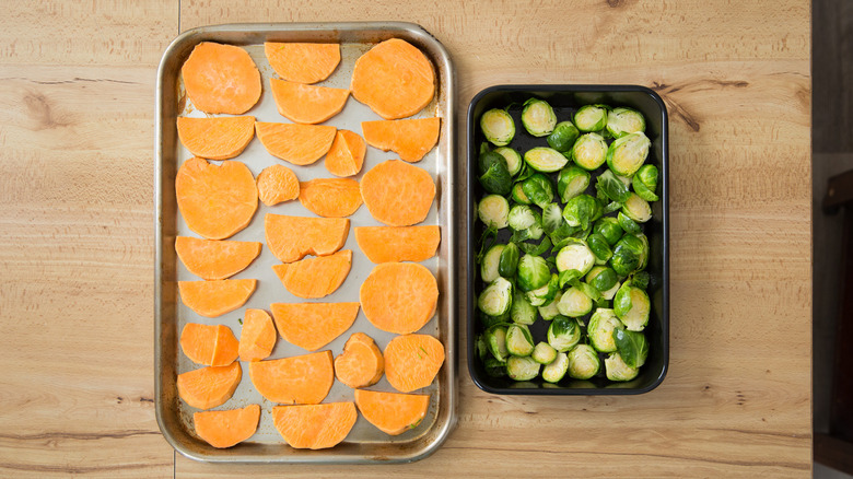 sliced vegetables on baking sheets 