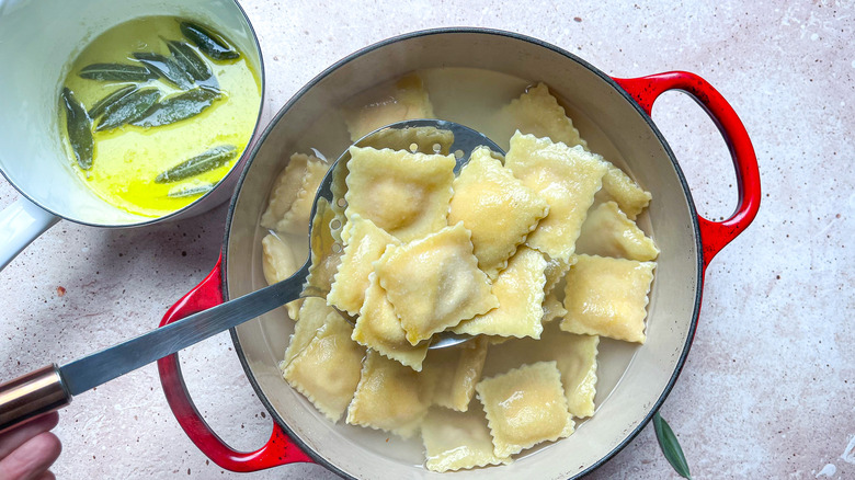 ladling cooked ravioli from pot