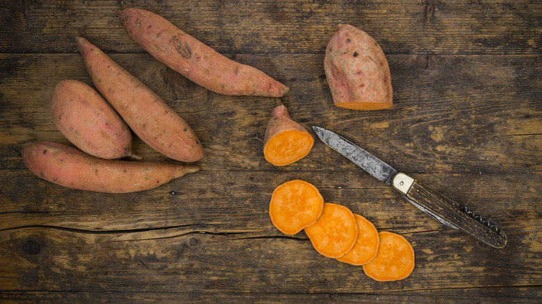 whole and sliced sweet potatoes