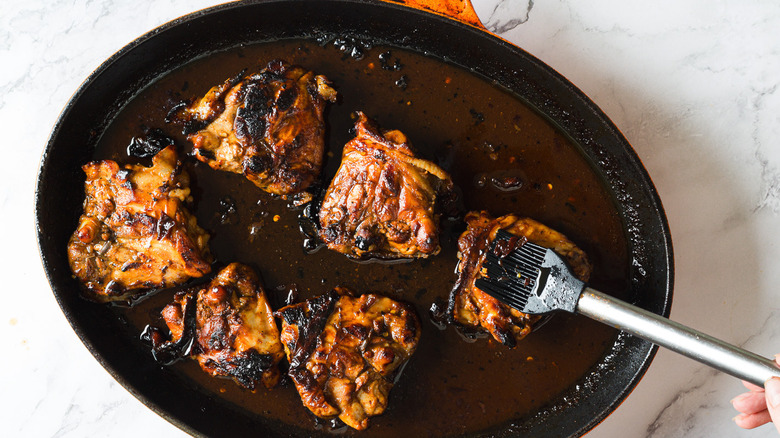 Brushing chicken with glaze