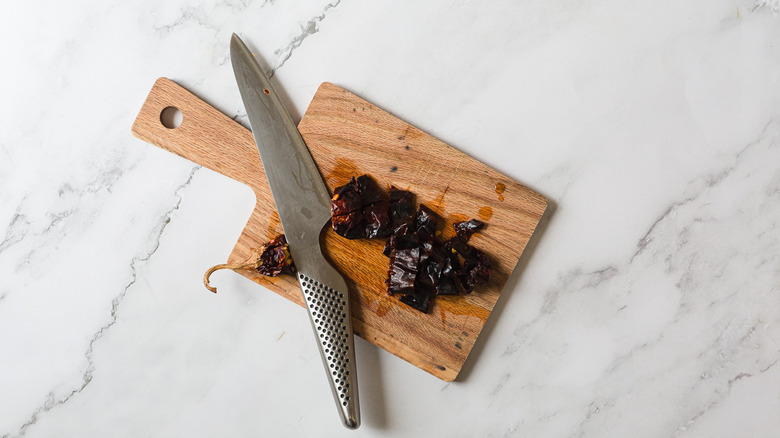 Pepper and knife on cutting board