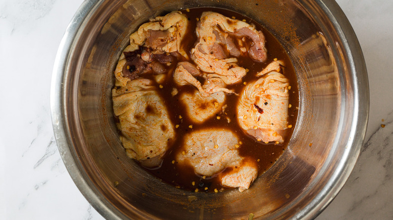 Sweet tea marinade with chicken in bowl