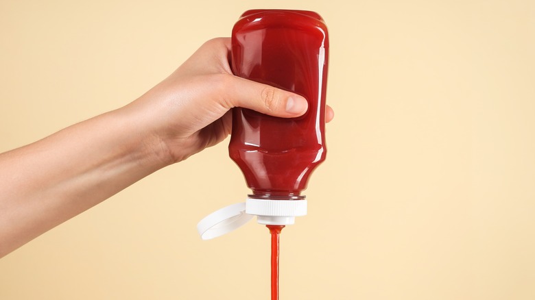 Squeezing bottle of ketchup