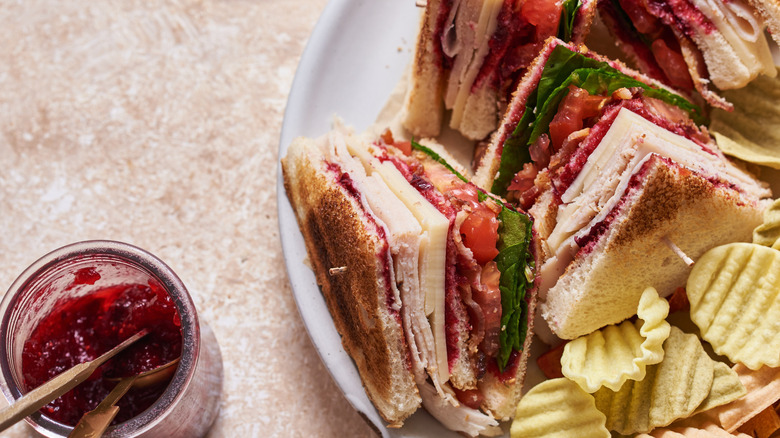 Turkey sandwiches, chips, and cranberry jam