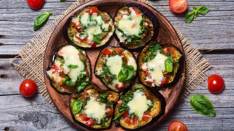 Eggplant pizzas on wooden plate