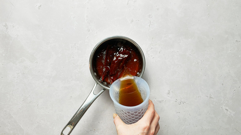 pouring broth over chiles