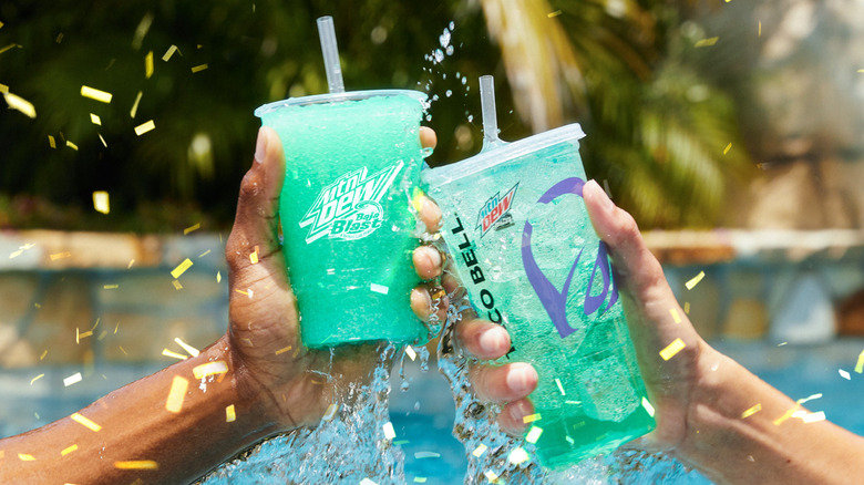 Hands holding two Taco Bell Baja Blasts