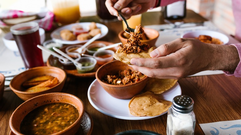 Adding toppings to a tostada