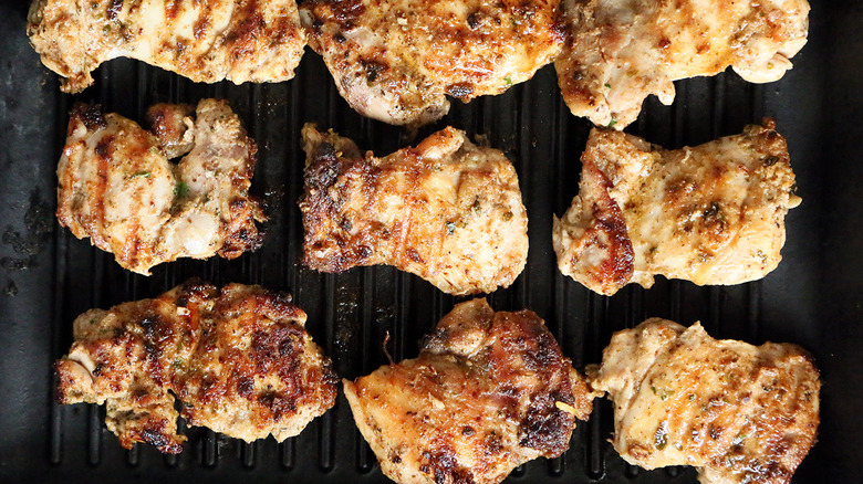 charred chicken thighs on grill