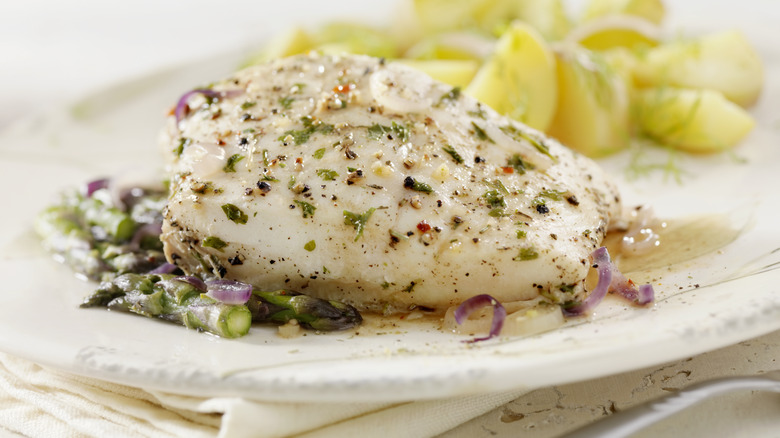 Poached white fish plated with vegetables