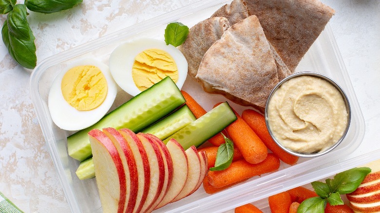 snack box with fruits, veggies, pita bread, and hummus