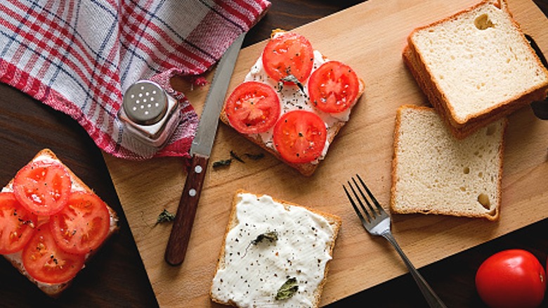 Tomato sandwich ingredients on cutting board