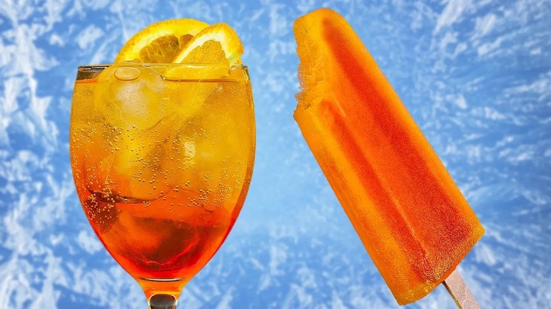 Aperol spritz and popsicle on blue background