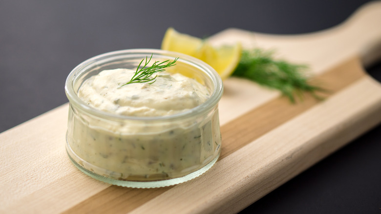 Jar of tartar sauce on cutting board