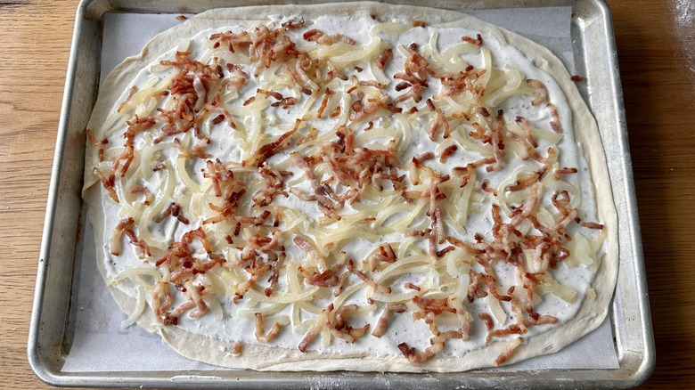 unbaked tarte flambée on pan