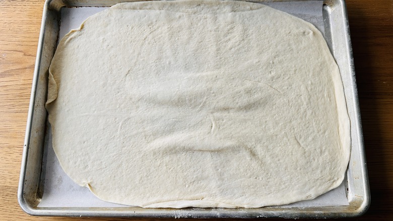 baking sheet lined with dough