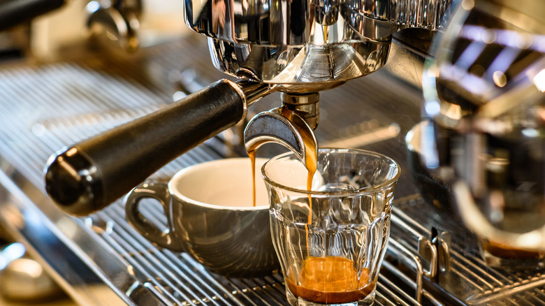 An espresso machine dripping coffee