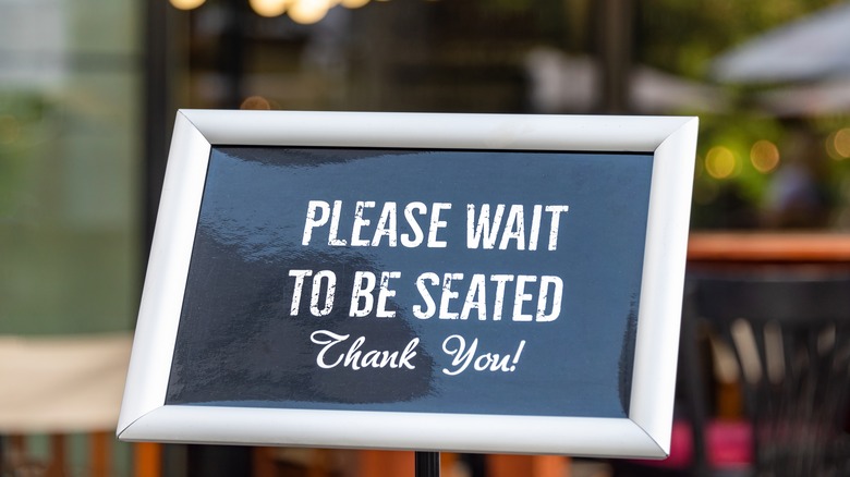 sign at restaurant host stand