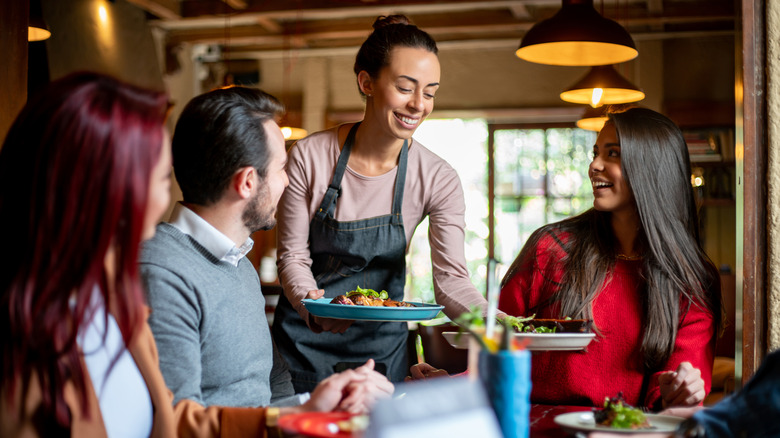 person serving food at restaurant