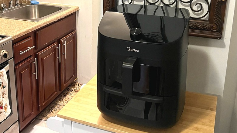 Midea Two Zone Air Fryer on a small table