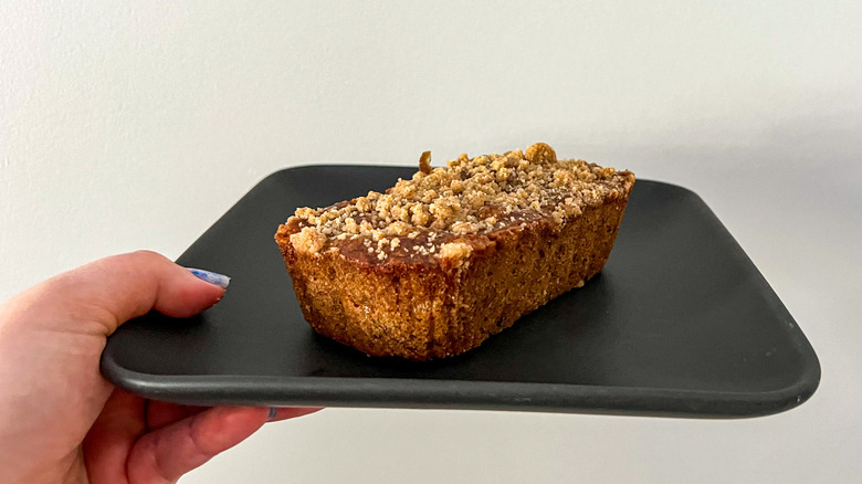 Hand holding plate with mini banana bread