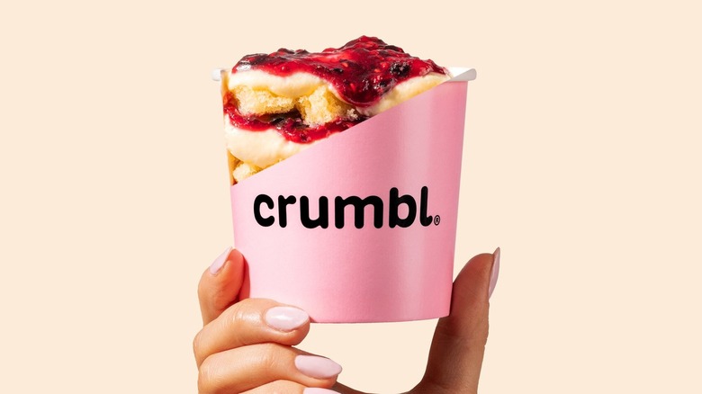 hand holding Crumbl dessert