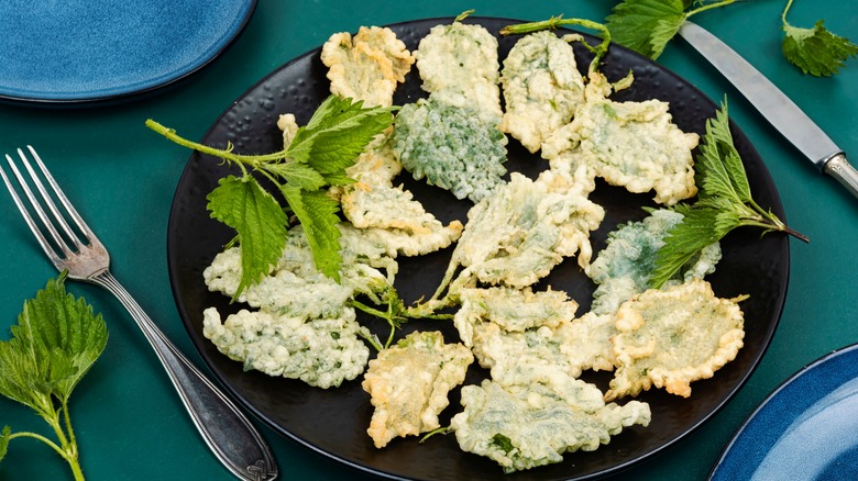 tempura fried nettles on a black plate