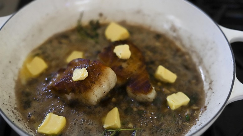 chilean sea bass in pan with butter