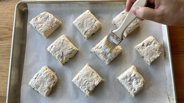 Brushing biscuit tops with buttermilk