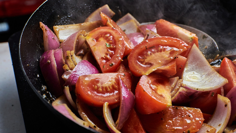 stir frying ingredients in a wok