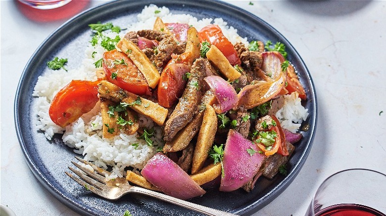 lomo saltado on plate with rice