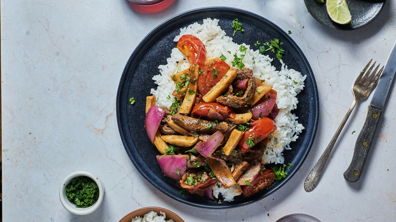 lomo saltado plated with rice