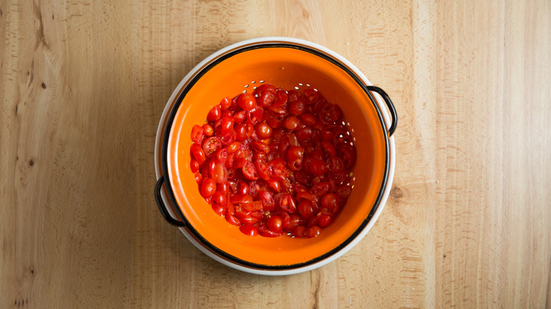 sliced tomatoes in colander 