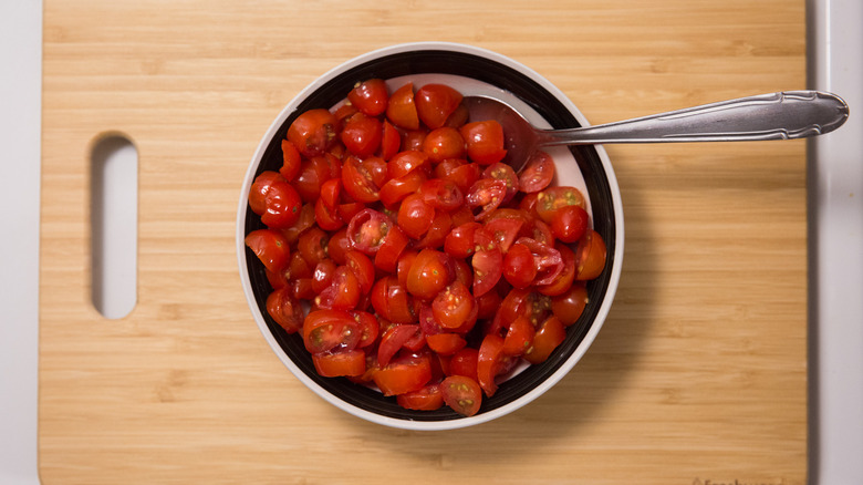 sliced grape tomatoes in bowl 