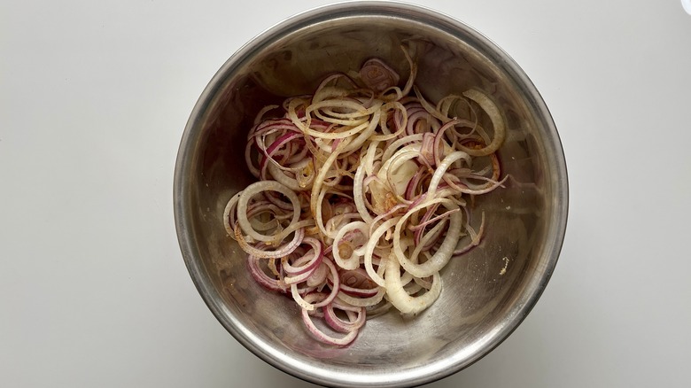 sliced onions in metal bowl