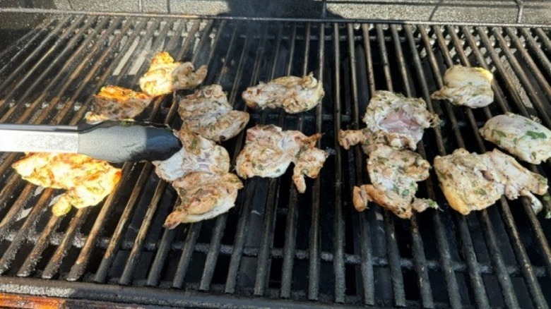 partially cooked chicken on grill