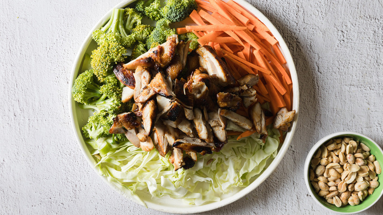 Veggies with chicken on white plate