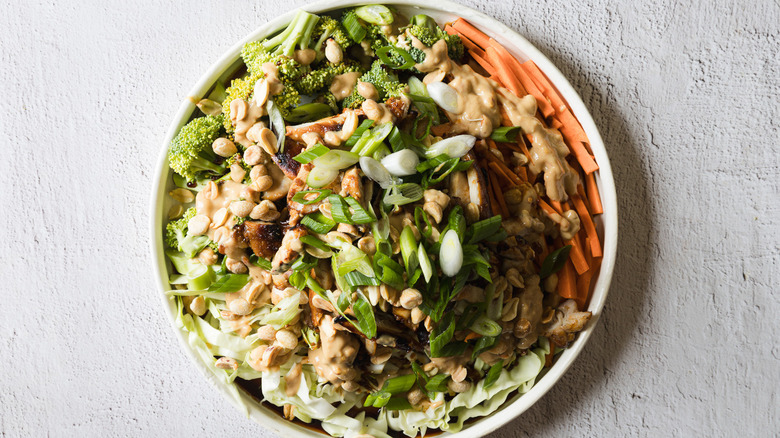 Salad with dressing on white plate