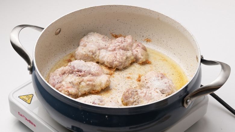 frying chicken in a pan