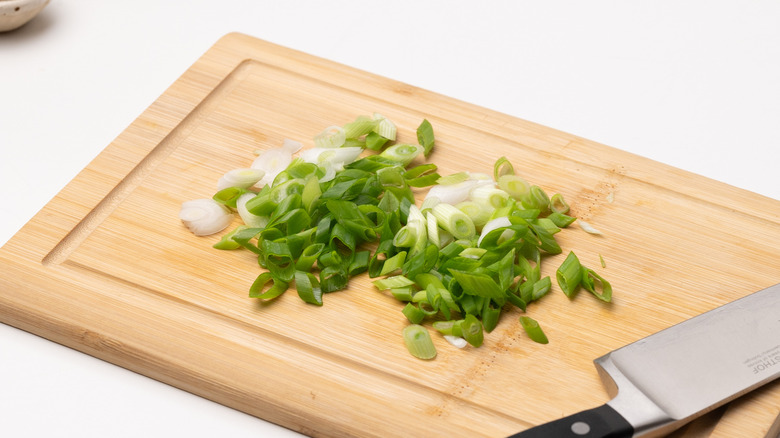 sliced scallions on chopping board