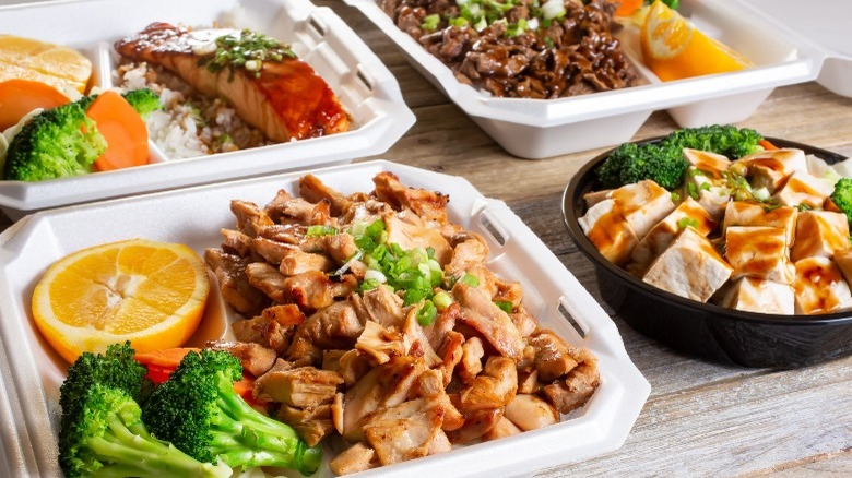 Multiple dishes of takeout teriyaki