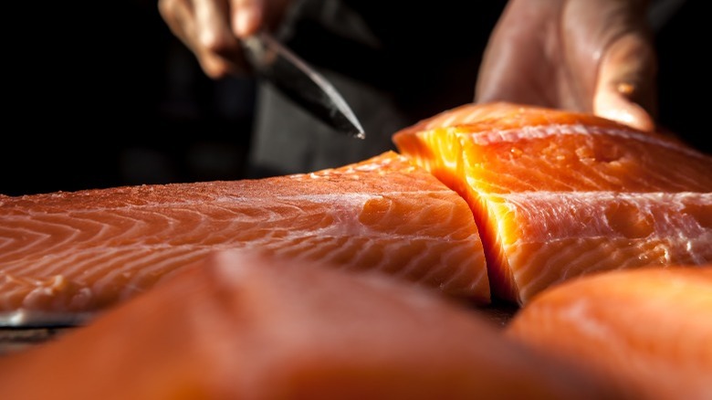 fresh salmon being sliced