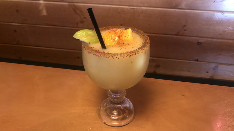 Texas Roadhouse mango margarita with tajin rim