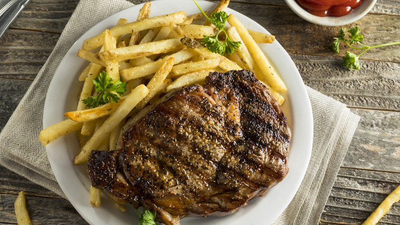 Steak with fries and garnish