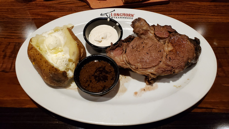 prime rib dinner with a baked potato side from LongHorn Steakhouse