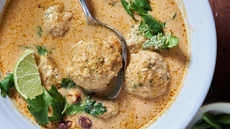 tom kha meatball soup close-up with spoon