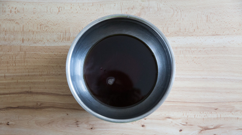 Black tea in metal bowl