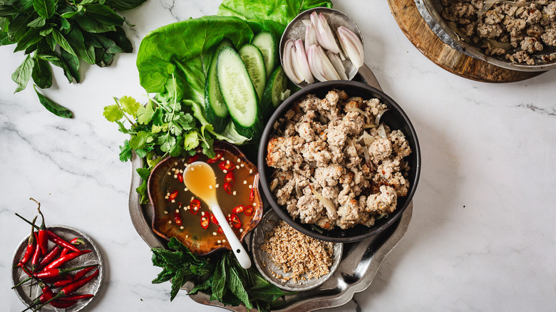 Overhead view of leftover turkey filling, Turkey wrap ingredients on a metal tray and red chilies